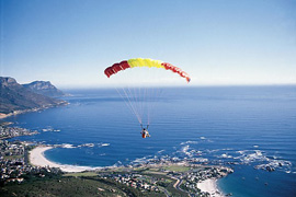 Paragilder descending to land at Camps Bay