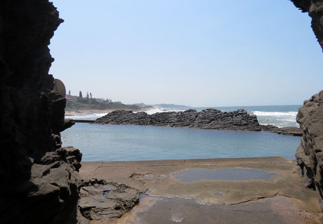 View of the pool and beach through the Hole in the wall