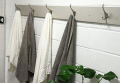 grey and white interiors with towels and toiletries suppplied